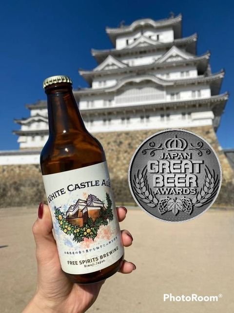 A woman is holding Free Spirits Brewing White castle Beer